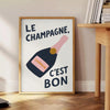 Póster de cocina 'Le Champagne C'est Bon' en tonos elegantes de verde y negro, disponible en tamaños 50x70 y 30x40, enmarcado